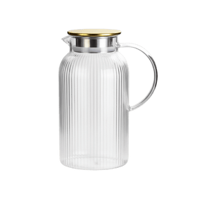 Clear glass pitcher with ribbed design and gold lid 