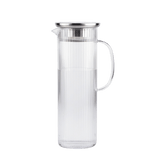Long clear glass pitcher with a silver lid 