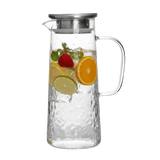 Engraved clear glass pitcher with a silver lid. The pitcher is filled with water and fruit slices