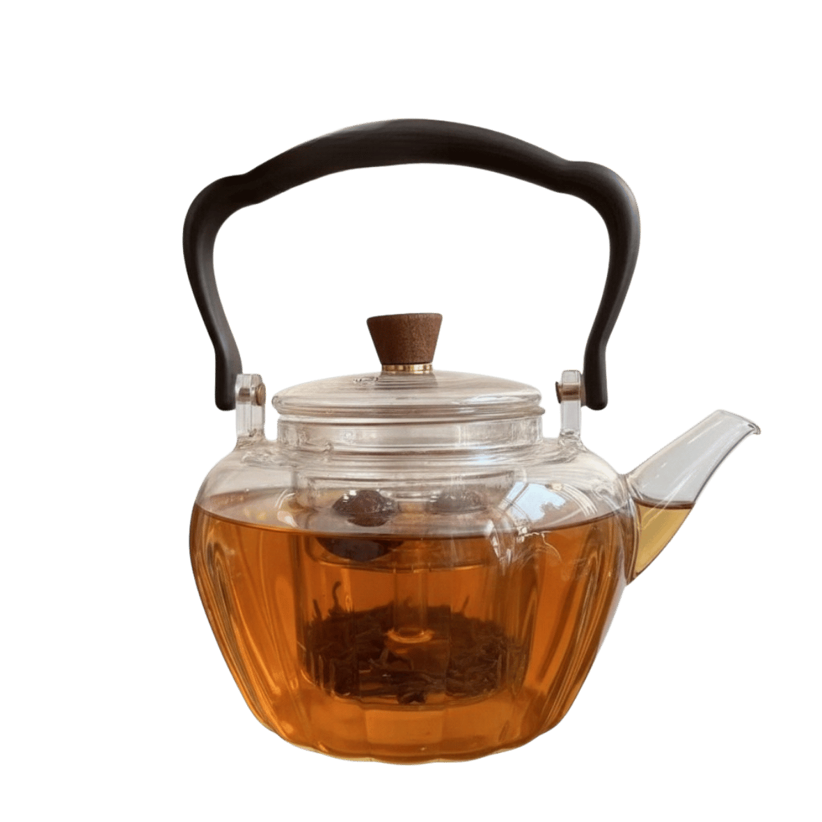 Clear glass teapot with black handle and lid knob with an internal measuring cup for defusing teas and herbs .. the image show the teapot filled with tea