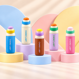 Five CHAKO LAB 750 ml bottles on pastel podiums including pink | زجاجات شكولاب بخمسة ألوان تشمل الوردي على خلفية ملونة